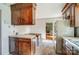 Functional kitchen with wood cabinets, and views into the adjacent dining room, offering a cozy and convenient layout at 1301 Old Farm Rd, Charlotte, NC 28226