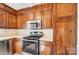Classic kitchen with wood cabinets, stainless steel oven, and sleek countertops, offering a functional cooking space at 1301 Old Farm Rd, Charlotte, NC 28226