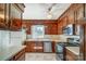 Traditional kitchen with wood cabinetry, stainless steel appliances, and a bright window view at 1301 Old Farm Rd, Charlotte, NC 28226