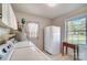 Bright laundry room with washer, dryer, and a window offering outside views at 1301 Old Farm Rd, Charlotte, NC 28226