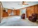 Spacious living room with wood-paneled walls, a fireplace, and access to stairs at 1301 Old Farm Rd, Charlotte, NC 28226