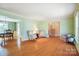Spacious living room with hardwood floors, and an open layout leading into the dining area and staircase at 1301 Old Farm Rd, Charlotte, NC 28226