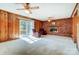 Comfortable living room with a brick fireplace, wood-paneled walls, and a sliding glass door at 1301 Old Farm Rd, Charlotte, NC 28226