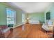 Bright living room features hardwood floors, large windows, and neutral decor, creating a serene and inviting atmosphere at 1301 Old Farm Rd, Charlotte, NC 28226