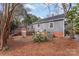 View of backyard with wood deck, mature trees, and well-maintained lawn at 1416 Woodland Dr, Charlotte, NC 28205