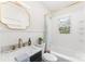 Bathroom featuring a marble countertop, stylish mirror, and shower-tub combination at 1416 Woodland Dr, Charlotte, NC 28205