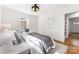 Bright bedroom featuring hardwood floors, a patterned rug, and a view to the exterior at 1416 Woodland Dr, Charlotte, NC 28205