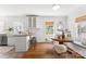 Bright breakfast nook with wood floors, built-in seating, and a charming round table near a window at 1416 Woodland Dr, Charlotte, NC 28205