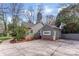 Exterior view of home with a well-maintained lawn, mature trees, and a private driveway at 1416 Woodland Dr, Charlotte, NC 28205
