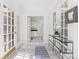 Bright hallway with white tile flooring and doors that let in natural light at 1416 Woodland Dr, Charlotte, NC 28205