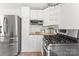 Bright kitchen with stainless steel appliances, white cabinets, and modern countertops at 1416 Woodland Dr, Charlotte, NC 28205