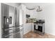 Well-lit kitchen featuring stainless steel appliances, white cabinetry, and granite countertops at 1416 Woodland Dr, Charlotte, NC 28205