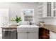 Bright kitchen showcasing a farmhouse sink, granite countertops, and stainless steel dishwasher at 1416 Woodland Dr, Charlotte, NC 28205