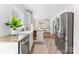 Open-concept kitchen boasts stainless steel appliances, granite countertops, and ample natural light at 1416 Woodland Dr, Charlotte, NC 28205