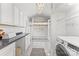 Laundry room featuring white cabinets, a loft bed, and modern appliances at 1416 Woodland Dr, Charlotte, NC 28205