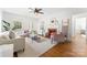 Bright living room with hardwood floors, fireplace, neutral furniture, and abundant natural light at 1416 Woodland Dr, Charlotte, NC 28205