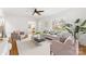 Inviting living room with a neutral sofa, accent chairs, hardwood floors, and natural light streaming in at 1416 Woodland Dr, Charlotte, NC 28205