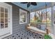 Relaxing screened-in porch with a swing, patterned tile floor, and a calming blue ceiling at 1416 Woodland Dr, Charlotte, NC 28205