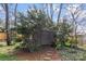 Storage shed surrounded by lush greenery and natural landscaping at 1416 Woodland Dr, Charlotte, NC 28205