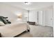Bright bedroom featuring neutral tones, plush carpet, a decorative elephant, and natural light through the window at 14815 Superior St, Charlotte, NC 28273
