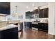 Open kitchen featuring dark cabinets, stone countertops, and stainless steel appliances at 14815 Superior St, Charlotte, NC 28273