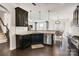 Well-lit kitchen with dark cabinets, granite countertops, and stainless steel appliances at 14815 Superior St, Charlotte, NC 28273