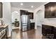 Bright kitchen with stainless steel refrigerator and arched doorway to the dining room at 14815 Superior St, Charlotte, NC 28273