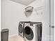 Laundry room featuring modern washer and dryer appliances, plus practical storage at 14815 Superior St, Charlotte, NC 28273