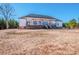 Expansive backyard of home featuring a covered back porch and stairs leading down to the yard at 150 Belk Estate Dr, Mooresville, NC 28115