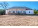 Enjoy this large backyard featuring a covered porch with ceiling fans, perfect for relaxing outdoors at 150 Belk Estate Dr, Mooresville, NC 28115