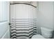 Bathroom features a striped shower curtain and a commode at 150 Belk Estate Dr, Mooresville, NC 28115