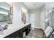 Bright bathroom with marble countertops, and sinks, rustic wooden mirrors, and a tiled walk-in shower at 150 Belk Estate Dr, Mooresville, NC 28115