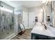 Modern bathroom boasts a double vanity, rustic mirrors, and a walk-in shower with stylish tiling at 150 Belk Estate Dr, Mooresville, NC 28115