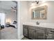Bathroom vanity features a marble countertop, gray cabinets, framed mirror, and views into a bedroom at 150 Belk Estate Dr, Mooresville, NC 28115