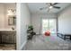 Bonus room with seating, shelving, a ceiling fan, slider to a deck, and a bathroom vanity at 150 Belk Estate Dr, Mooresville, NC 28115
