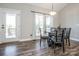 Charming dining area with a round wooden table, natural light, and a view of the outdoors at 150 Belk Estate Dr, Mooresville, NC 28115