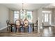 Charming dining area with large windows and a unique, rustic table set perfect for Gathering gatherings at 150 Belk Estate Dr, Mooresville, NC 28115