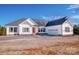 Beautiful one-story home with white siding, dark shutters and a red front door with attached two-car garage at 150 Belk Estate Dr, Mooresville, NC 28115