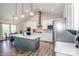 Modern kitchen features stainless steel appliances, a large island, and ample cabinet space at 150 Belk Estate Dr, Mooresville, NC 28115