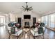 Cozy living room with a large fan, stone fireplace, and comfortable seating at 150 Belk Estate Dr, Mooresville, NC 28115