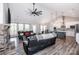 Spacious living room with a cozy stone fireplace and an open layout connecting to the kitchen at 150 Belk Estate Dr, Mooresville, NC 28115