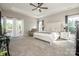 Spacious main bedroom suite with tray ceilings, a ceiling fan, and access to a private balcony at 150 Belk Estate Dr, Mooresville, NC 28115