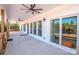 View of the long, covered porch with fans and sliding glass doors to the interior at 150 Belk Estate Dr, Mooresville, NC 28115