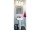 Powder room with a pedestal sink, framed mirror, wood-look flooring, and updated fixtures at 150 Belk Estate Dr, Mooresville, NC 28115