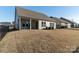 A spacious backyard featuring a covered patio with outdoor furniture at 15035 Batteliere Dr, Charlotte, NC 28278