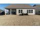 A sprawling backyard with a covered patio and ample space for recreation at 15035 Batteliere Dr, Charlotte, NC 28278