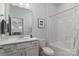 Bright bathroom featuring vanity, tub and shower, a toilet and neutral tones, creating a spa-like retreat at 15035 Batteliere Dr, Charlotte, NC 28278
