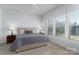 Bright bedroom featuring plush carpet, natural light, and ceiling fan for added comfort at 15035 Batteliere Dr, Charlotte, NC 28278