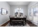 Bright dining room features a modern chandelier and a wooden table with seating for Gathering meals at 15035 Batteliere Dr, Charlotte, NC 28278