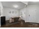 Bright dining room with dark wood floors, a modern table, and ample natural light at 15035 Batteliere Dr, Charlotte, NC 28278